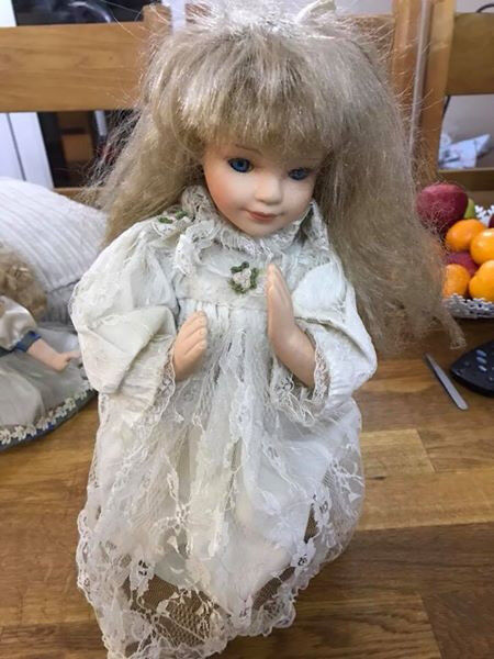 praying porcelain doll